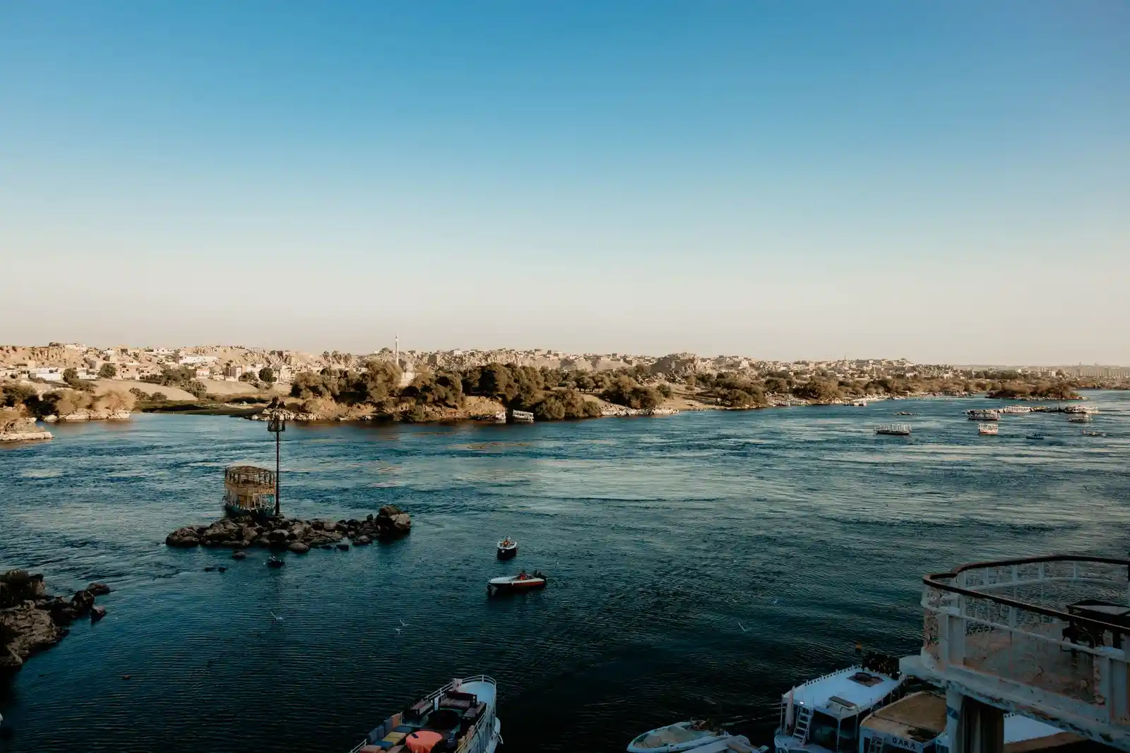 A boat and the river at Nile at Aswan under a blue sky