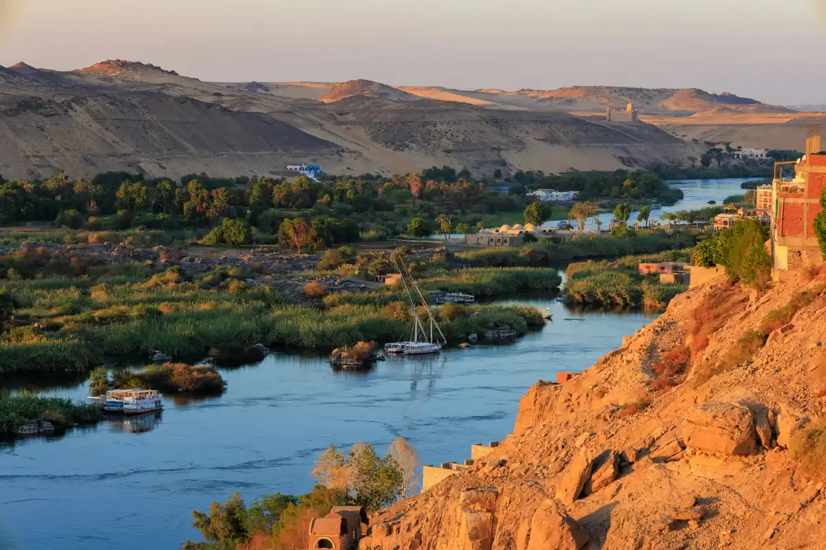 Desert sand, a boat and the river at Nile between Aswan and Luxor in Egypt