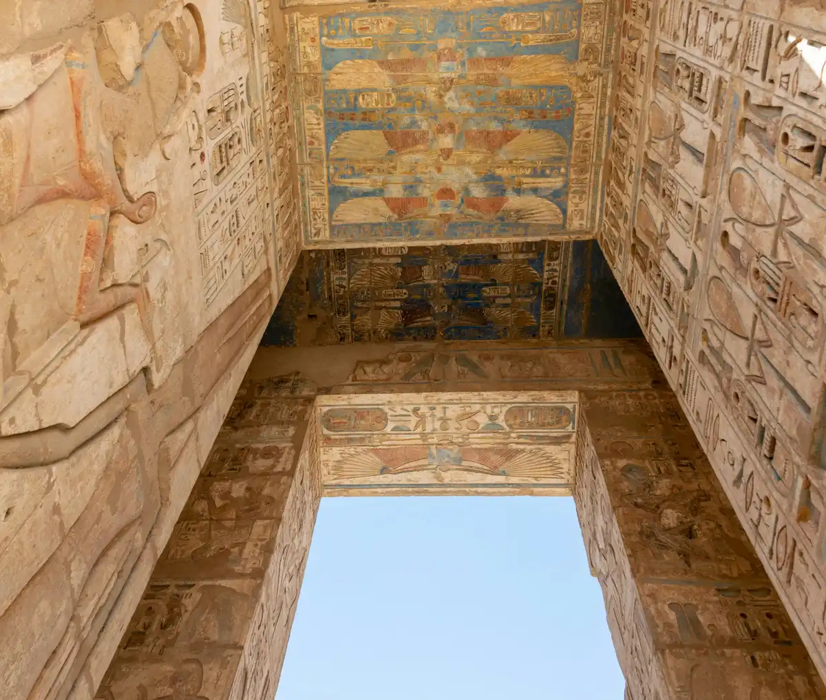 Hieroglyphs and buildings in Luxor, Egypt under a blue sky in daylight