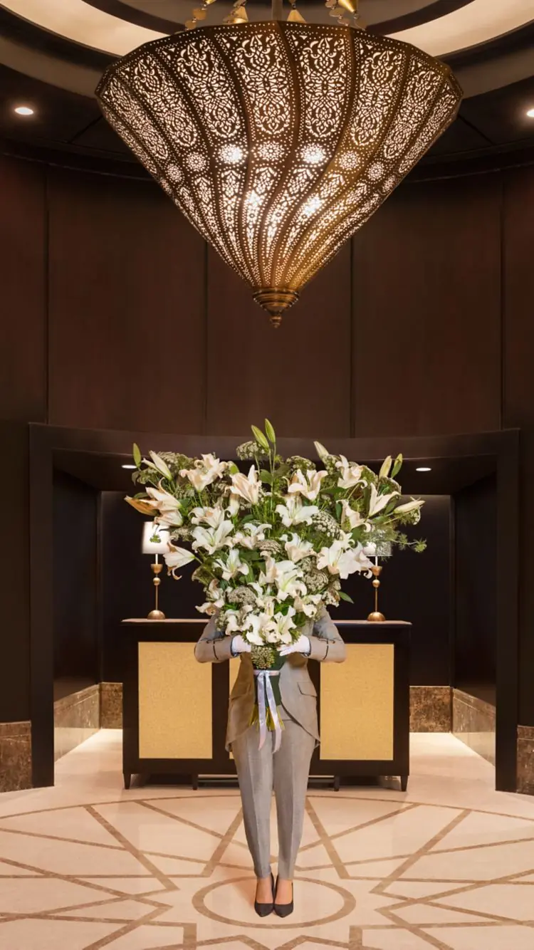 Butler carrying a floral arrangement at St Regis Cairo, Egypt