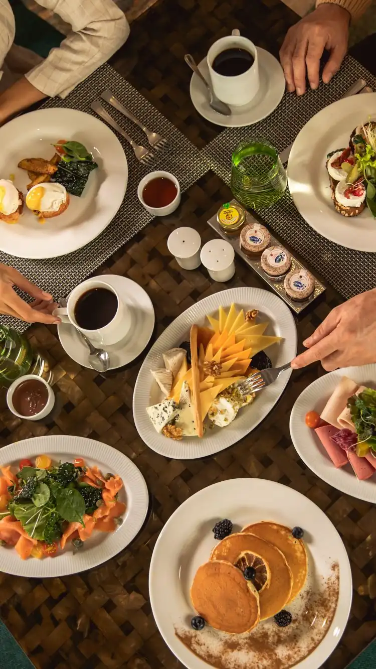 Breakfast spread with pancakes, cheese board, and coffee at The Nile Ritz-Carlton Cairo