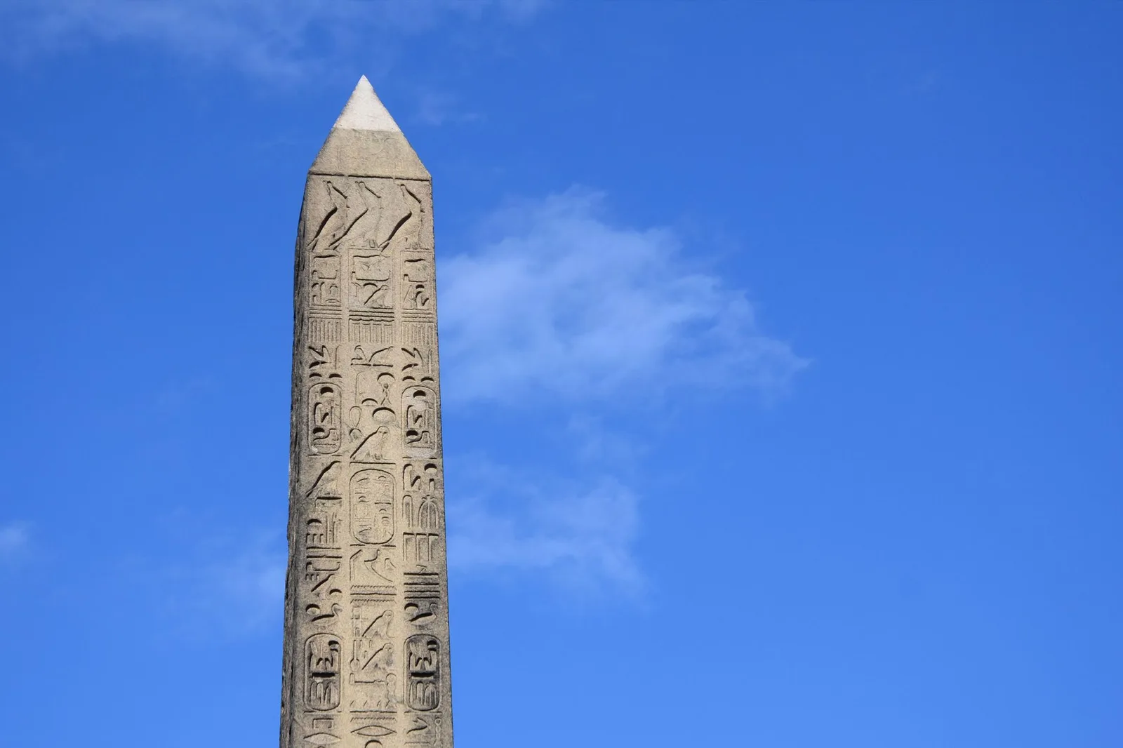 Hieroglyphs in close-up at Unfinished Obelisk in Aswan under a blue sky