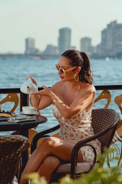 Guest enjoying coffee on a terrace at Sofitel Cairo Nile El Gezirah with Nile River views