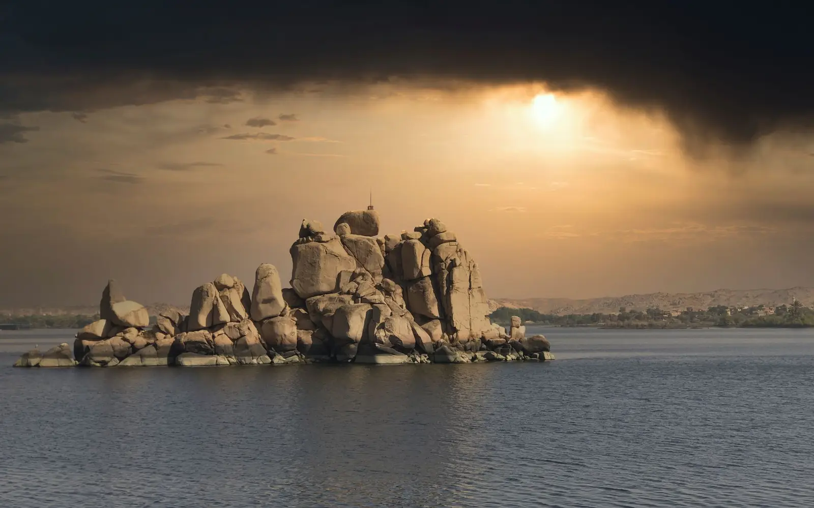 The river and stone at Nile at Aswan in Egypt at sunset