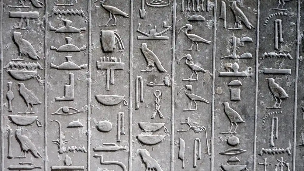 Pyramids, hieroglyphs, carved reliefs and a grey tomb at Saqqara in Giza, Egypt