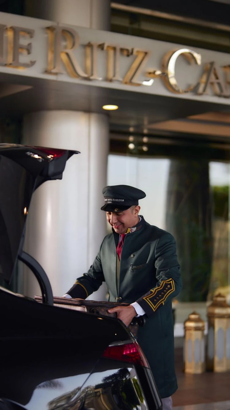 Bellman assisting with luggage at The Nile Ritz-Carlton Cairo entrance