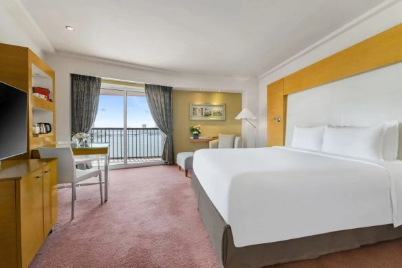Guest room with a balcony at Sofitel Cairo Nile El Gezirah overlooking the Nile River