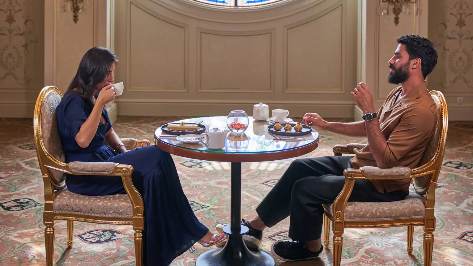 Guests having tea in an ornate hall at Four Seasons Hotel Cairo at The First Residence