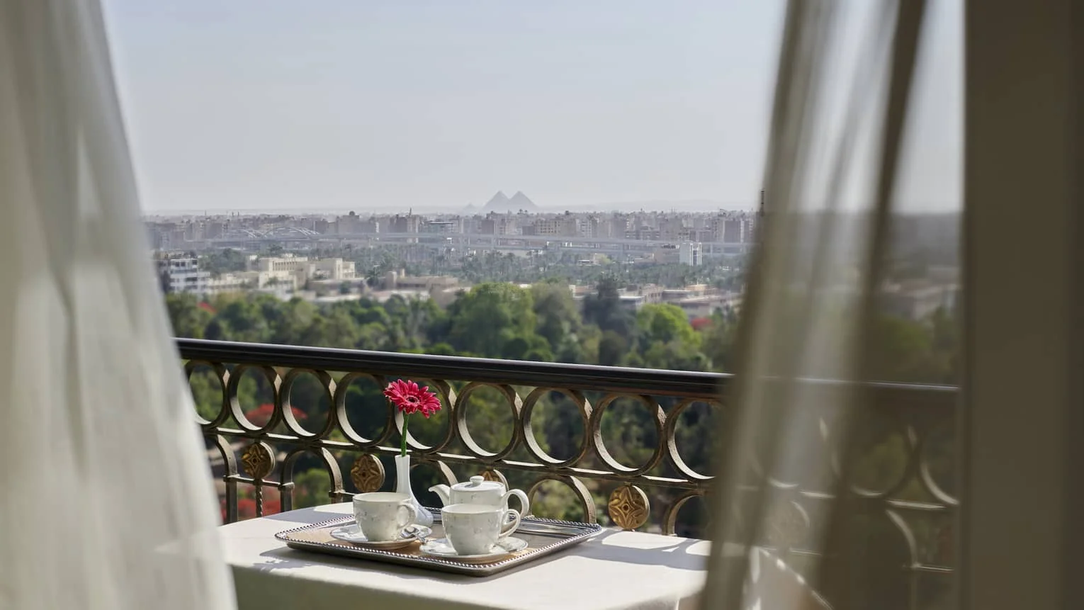Balcony breakfast tray with a distant pyramids view from Four Seasons Hotel Cairo at The First Residence