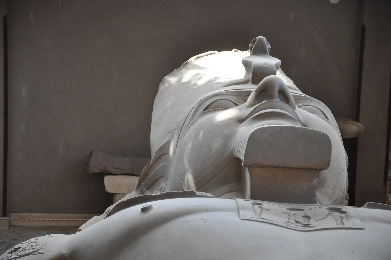 Hieroglyphs, statues and the river at the site of memphis egypt