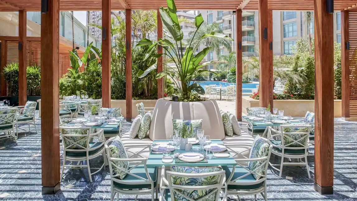 Outdoor restaurant terrace at Four Seasons Nile Plaza Cairo surrounded by gardens