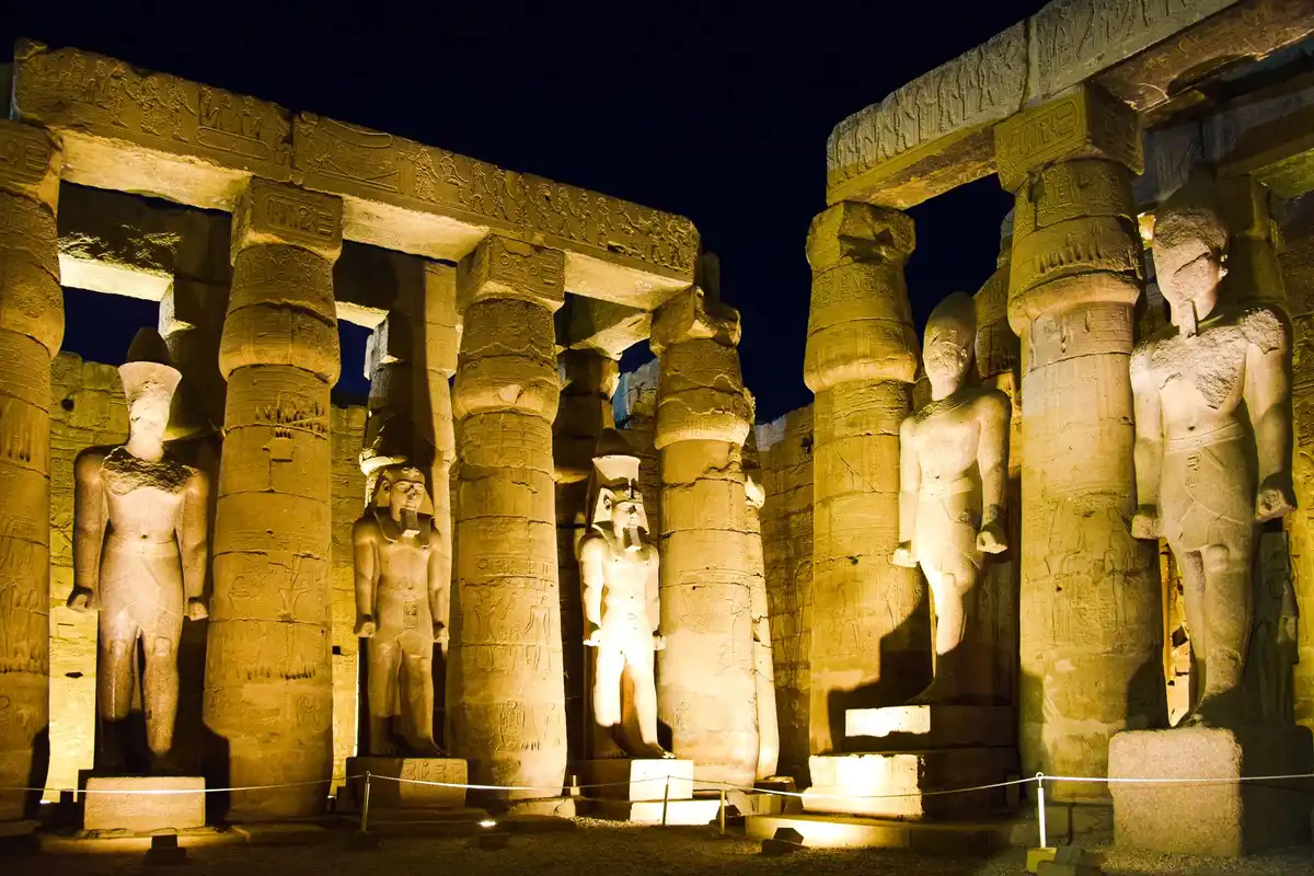 Statues and buildings at Luxor Temple in Egypt at night