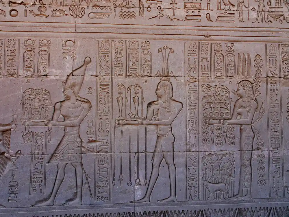 Carved reliefs, a temple and walls at dendera temple egypt