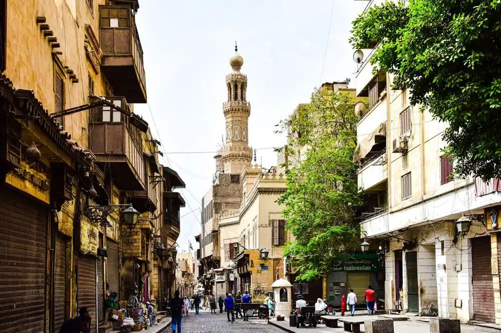 Medieval stone facades and lanterns along Al-Muizz Street in Islamic Cairo
