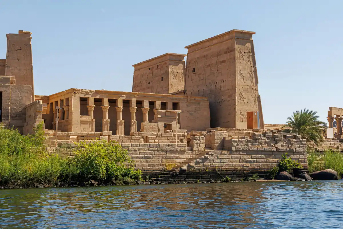 Carved reliefs, columns, the river and water at Philae Temple in Aswan, Egypt