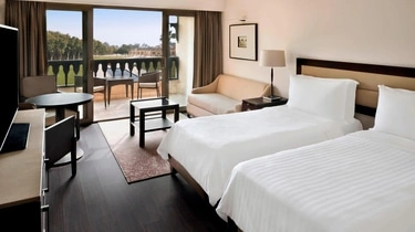 Guest room at Marriott Mena House Cairo with balcony access to the gardens