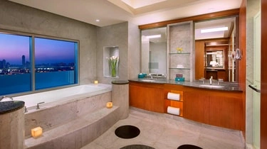 Bathroom with a soaking tub and Nile view at The Nile Ritz-Carlton Cairo