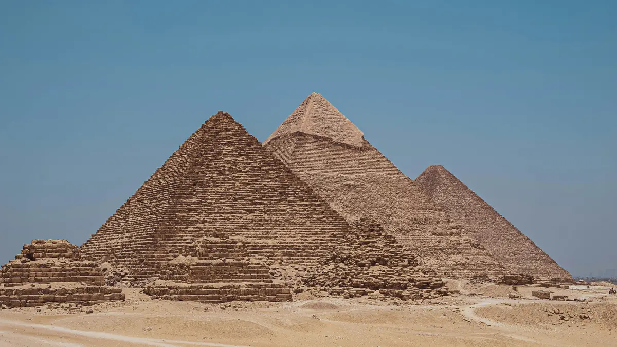 Desert sand at Giza Pyramids under a blue sky