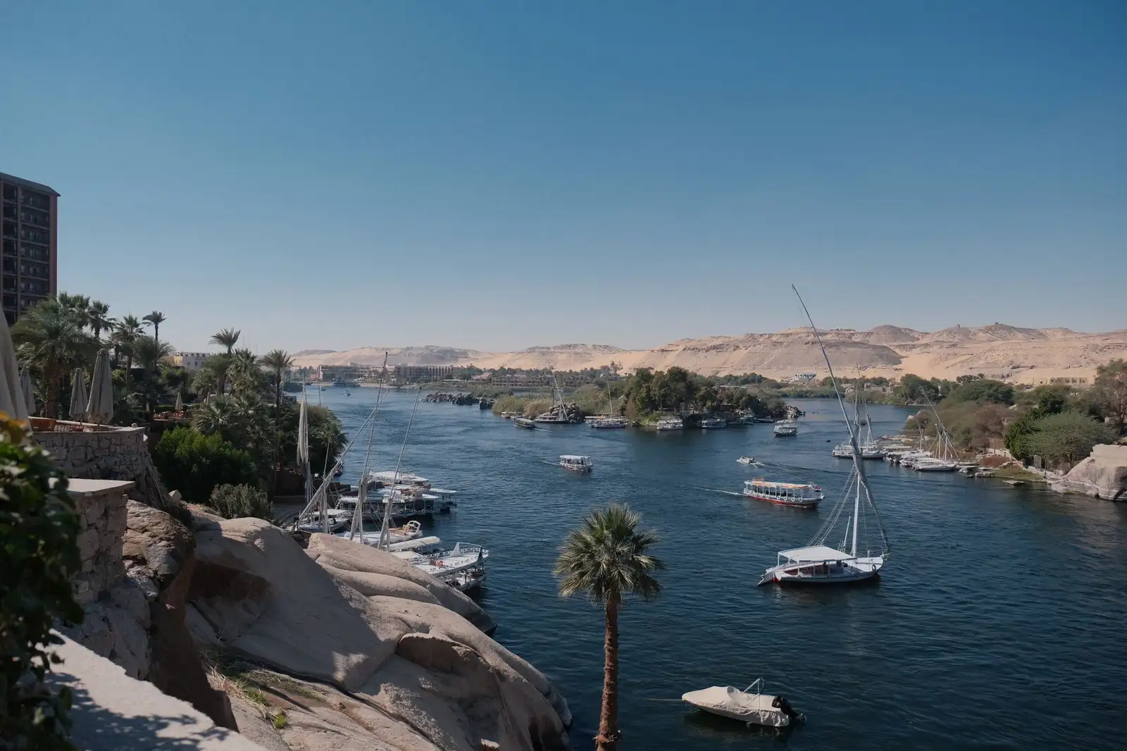A boat, the river and palms at Nile at Aswan in Egypt