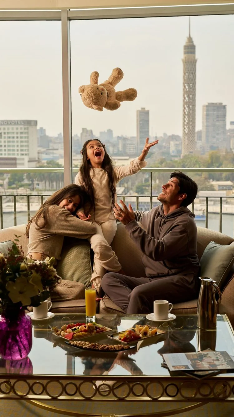 Family playing together in a suite at The Nile Ritz-Carlton Cairo with a Cairo Tower view