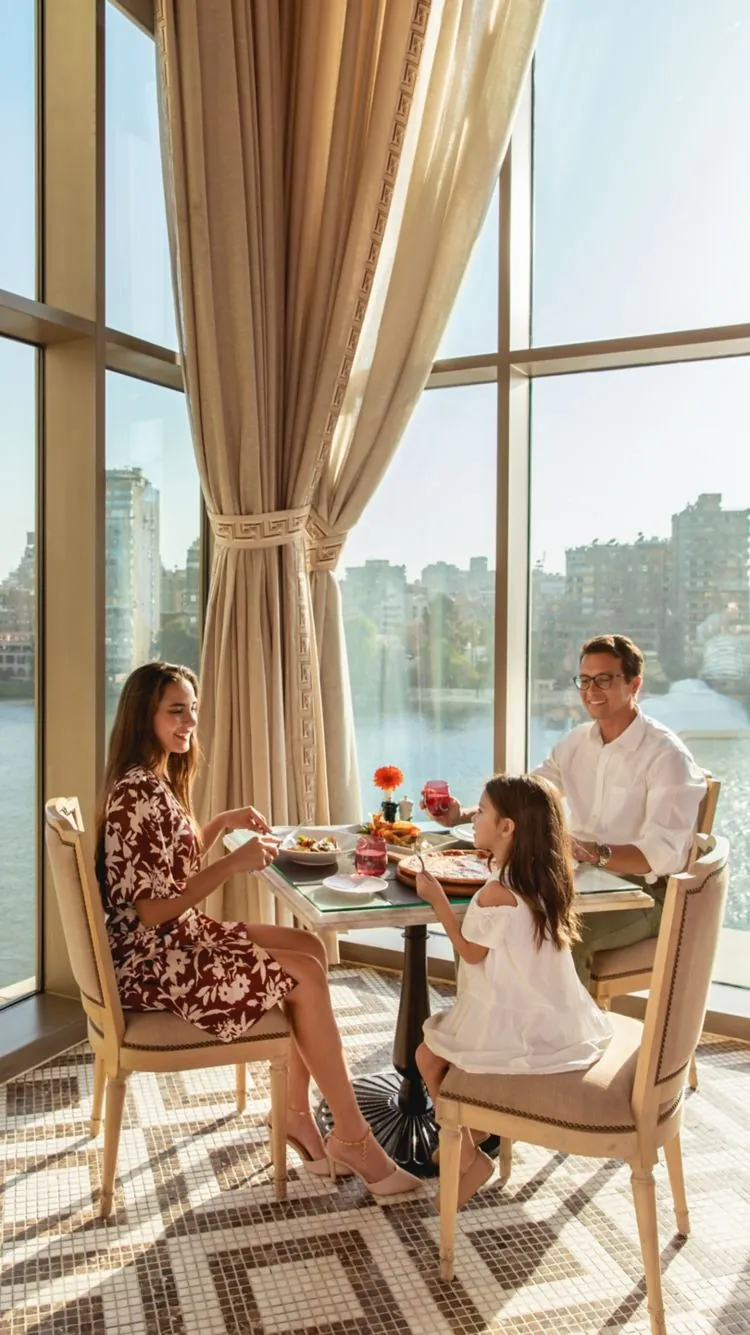 Family dining at La Zisa restaurant, The St Regis Cairo, with Nile views