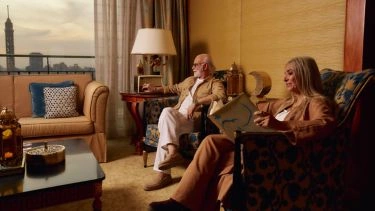 Couple relaxing in a suite at The Nile Ritz-Carlton Cairo with Cairo Tower and skyline views