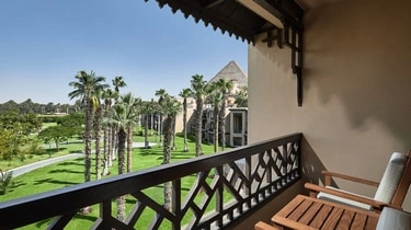 Private balcony at Marriott Mena House Cairo with palm trees and pyramid views