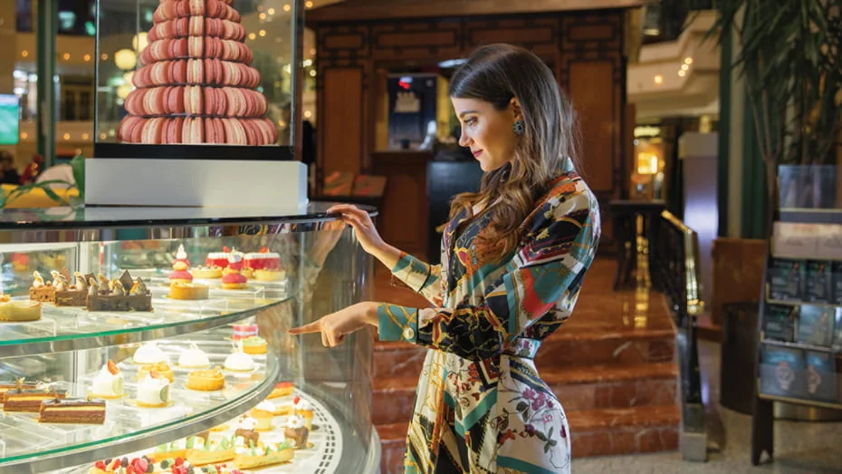 Guest browsing a patisserie dessert display at Four Seasons Hotel Cairo at The First Residence